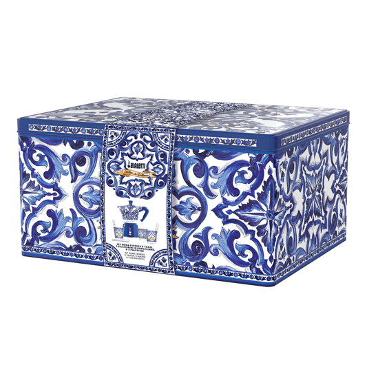 Elegant Bialetti espresso maker beside D&G luxury accessories, showcasing premium Italian style and craftsmanship.