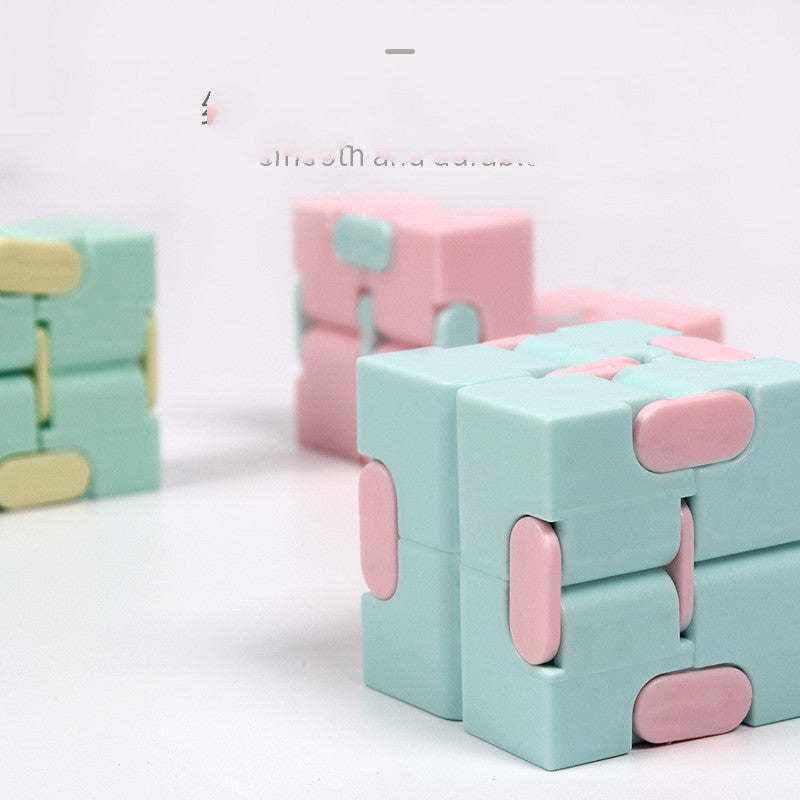 Infinity Cube finger puzzle with 8 rotating cubes, compact stress-relief toy in random colors.