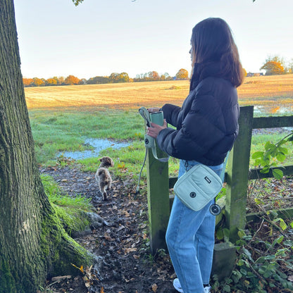 Mini dog walking bag in sage green waterproof nylon, crossbody design with zip compartments & poo bag dispenser