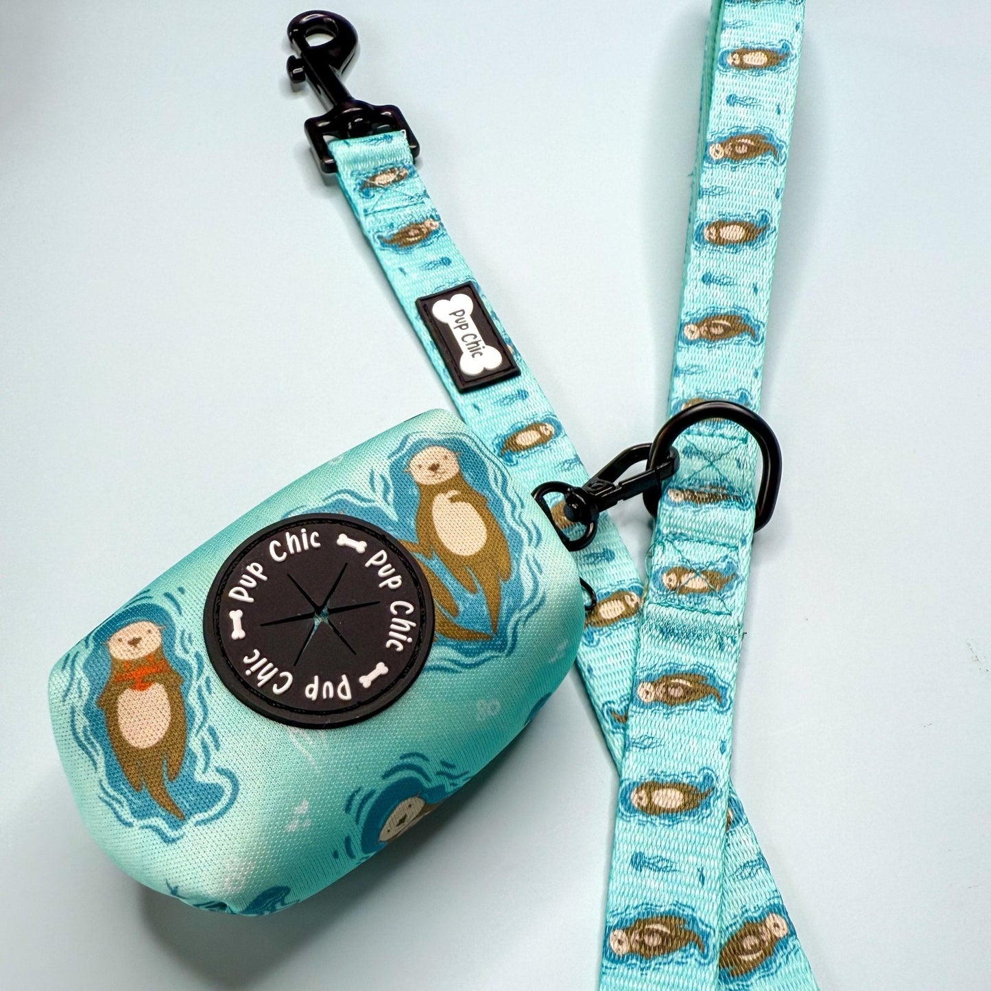 Otterly Lovely poo bag holder, compact water‑resistant design with otter print, clips to lead or belt