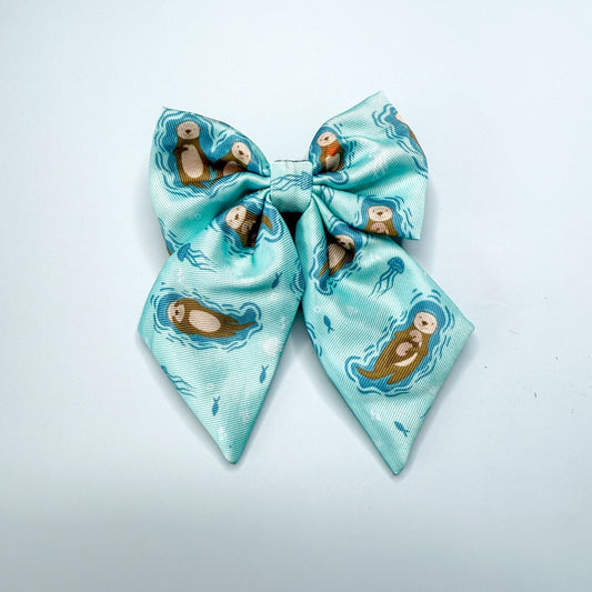 Otterly Lovely teal sailor bow with sea otter print, Velcro fastening, available in two sizes