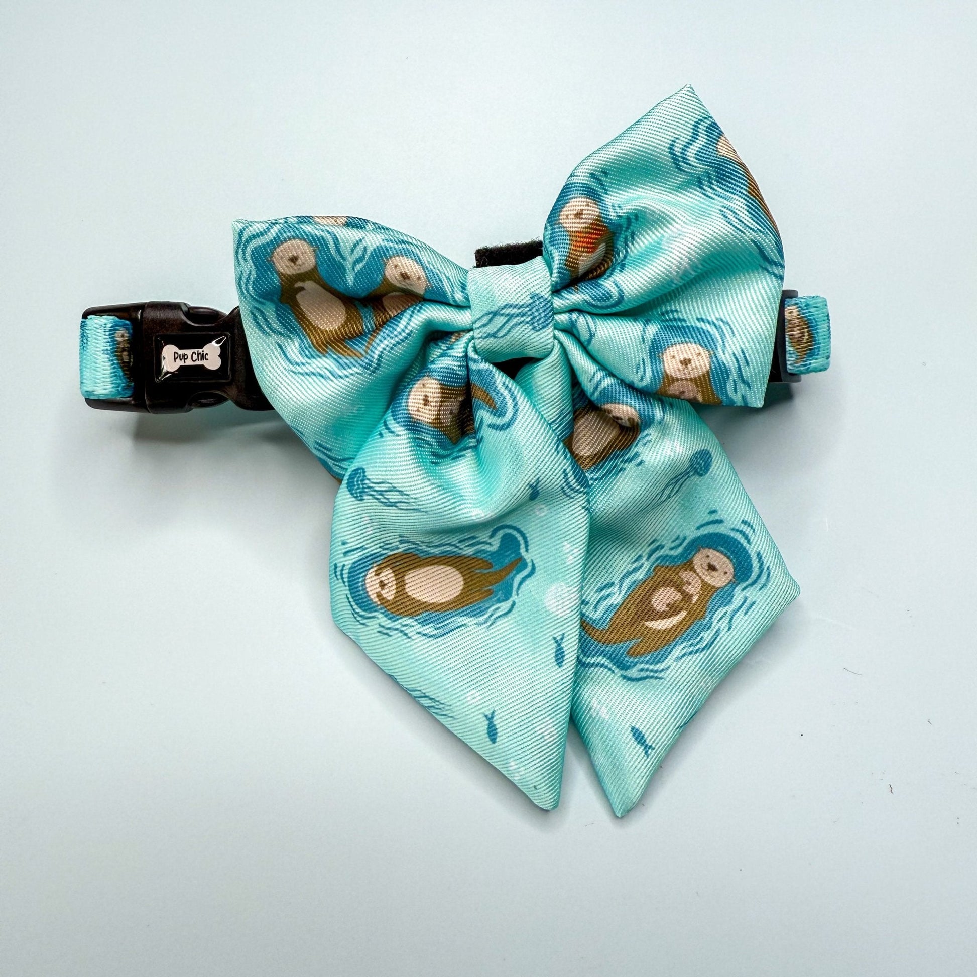 Otterly Lovely teal sailor bow with sea otter print, Velcro fastening, available in two sizes