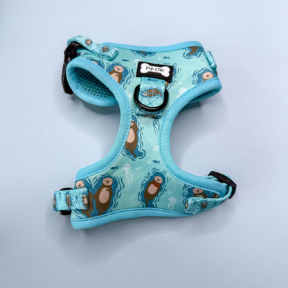 Otterly Lovely aqua step‑in dog harness with sea otter print, adjustable neck and chest straps