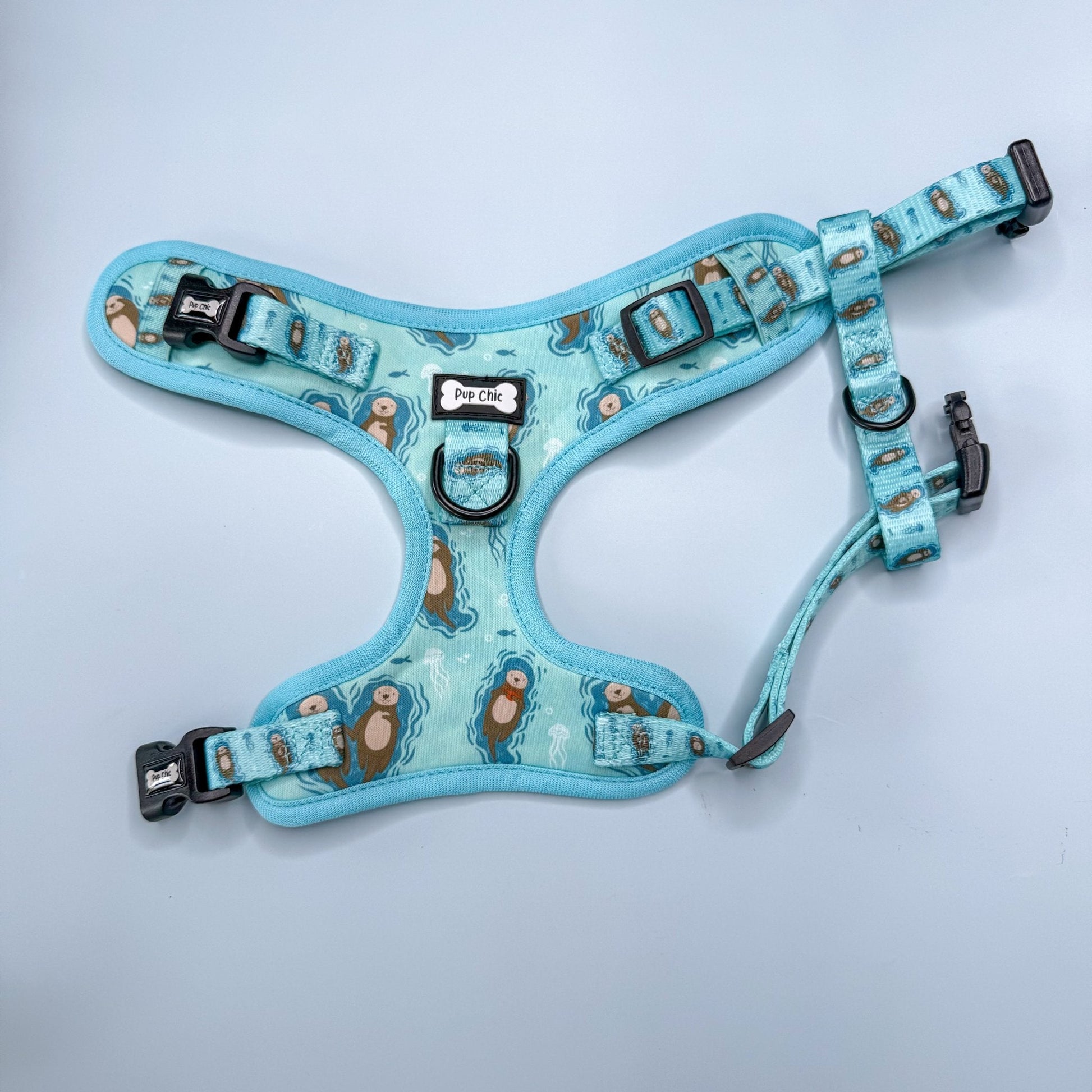 Otterly Lovely aqua step‑in dog harness with sea otter print, adjustable neck and chest straps