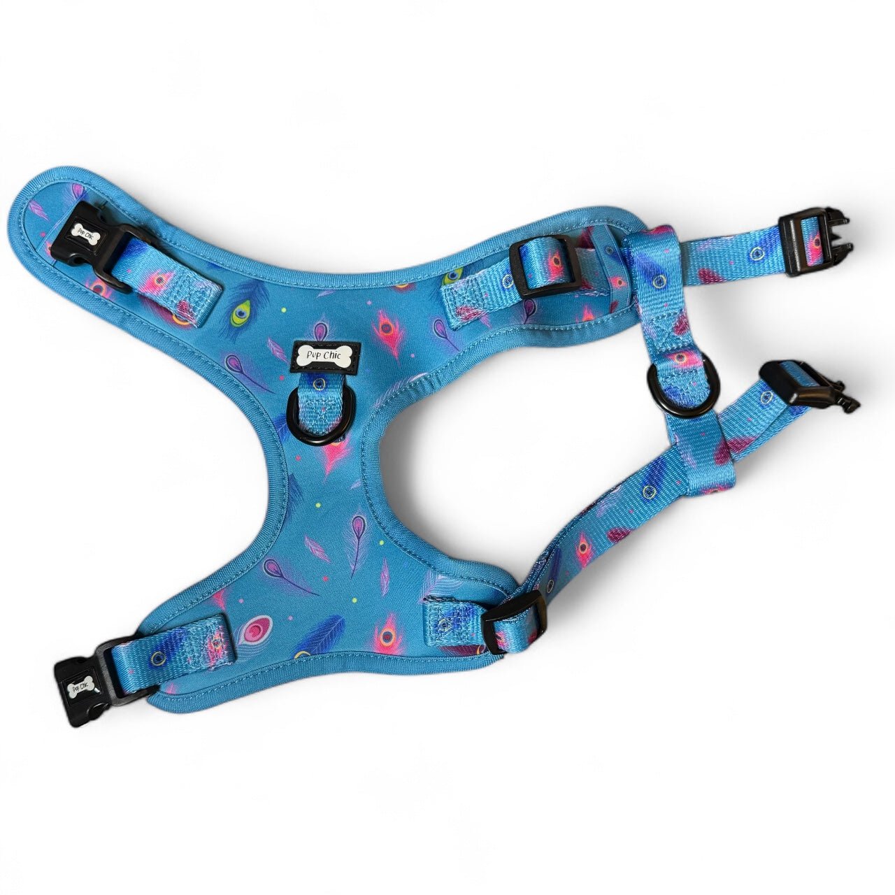 Power Peacock step‑in dog harness in teal with peacock feather print, adjustable neck and chest straps
