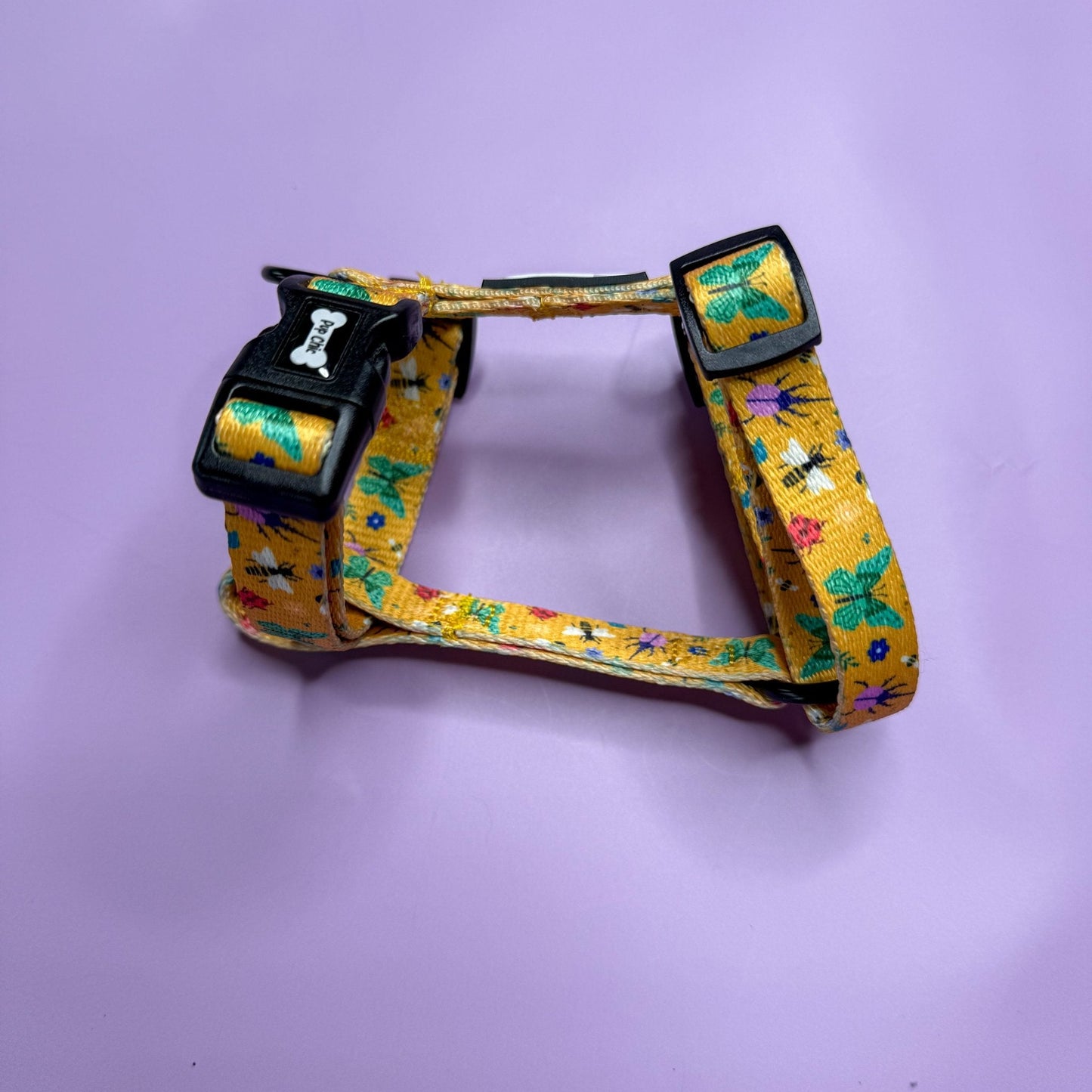 Summer Buzzin’ XXXS puppy harness in mustard yellow with colourful insect print, adjustable straps for tiny pets