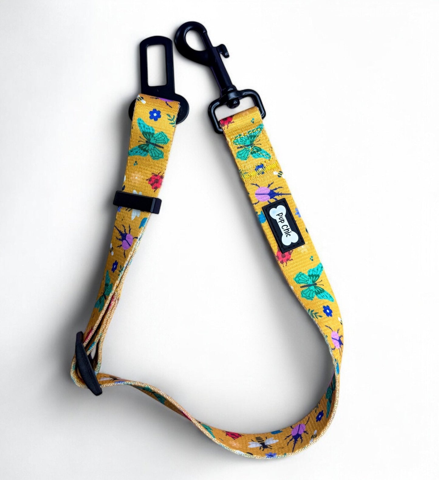 Summer Buzzin’ adjustable dog seat belt clip in mustard yellow with insect print